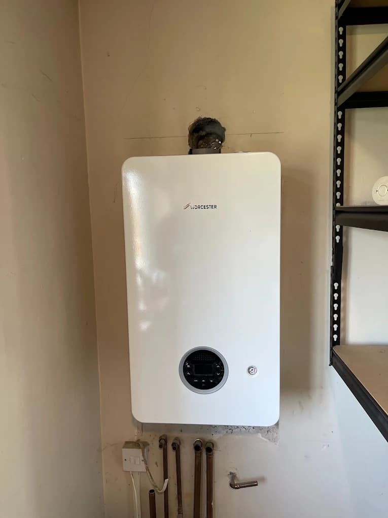 Combi boiler installed beside shelving in a utility room