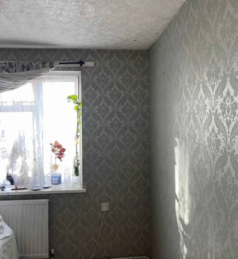 Radiator fitted beneath a living room window